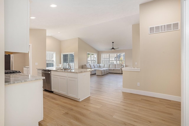 2519 Hunters Run Unit 101, Kalamazoo, MI 49048 - kitchen featuring dishwasher, sink, ceiling fan, light stone countertops, and white cabinetry