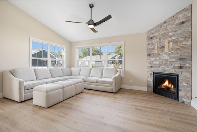 2519 Hunters Run Unit 101, Kalamazoo, MI 49048 - living room with a fireplace, light wood-type flooring, vaulted ceiling, and ceiling fan