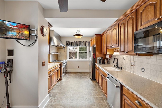 kitchen with ceiling fan, sink, stainless steel appliances, wall chimney range hood, and decorative backsplash