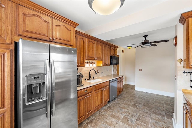 kitchen with appliances with stainless steel finishes, backsplash, ceiling fan, and sink