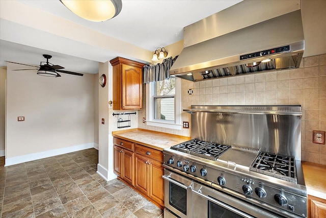 kitchen featuring decorative backsplash, range with two ovens, ceiling fan, and exhaust hood