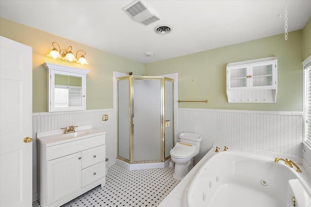 full bathroom featuring separate shower and tub, vanity, and toilet