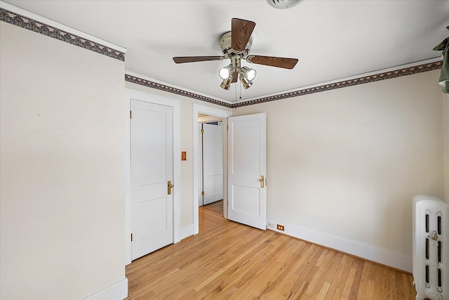 unfurnished bedroom with ceiling fan and light hardwood / wood-style floors