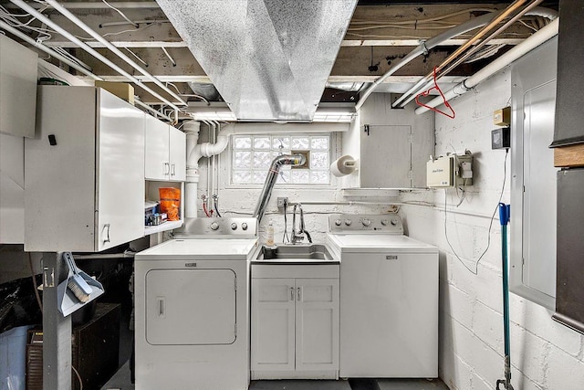 clothes washing area featuring cabinets, separate washer and dryer, and sink