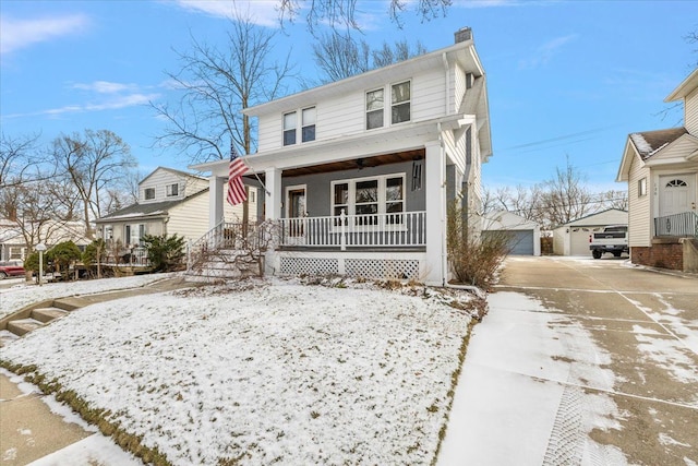 front of property with an outdoor structure, a porch, and a garage