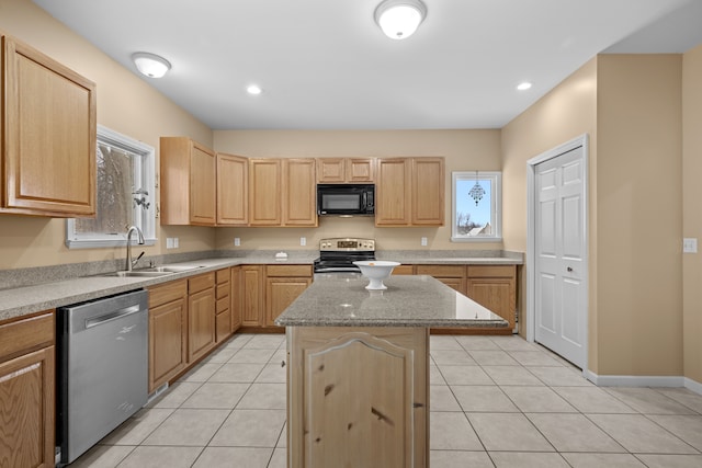 3700 Marie Meadows Dr, White Lake, MI 48383 - kitchen featuring appliances with stainless steel finishes, light brown cabinetry, a sink, a center island, and light tile patterned floors