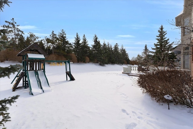 snowy yard with a playground