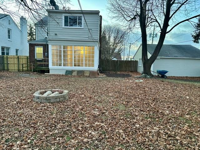 back of property with a fire pit