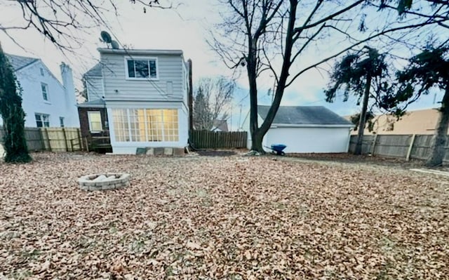 back of house with a fenced backyard and a sunroom