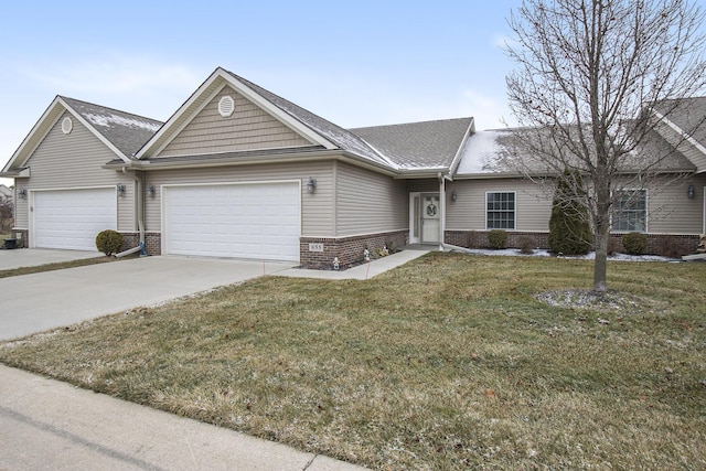 single story home with a garage and a front lawn