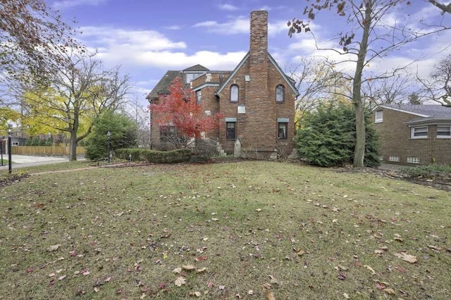 view of side of home with a yard