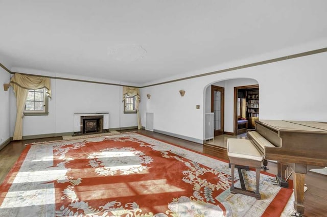 unfurnished living room with hardwood / wood-style floors and ornamental molding