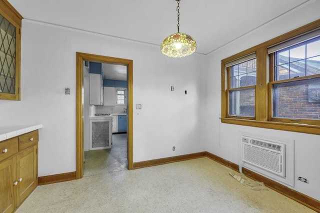 unfurnished dining area featuring a wall unit AC