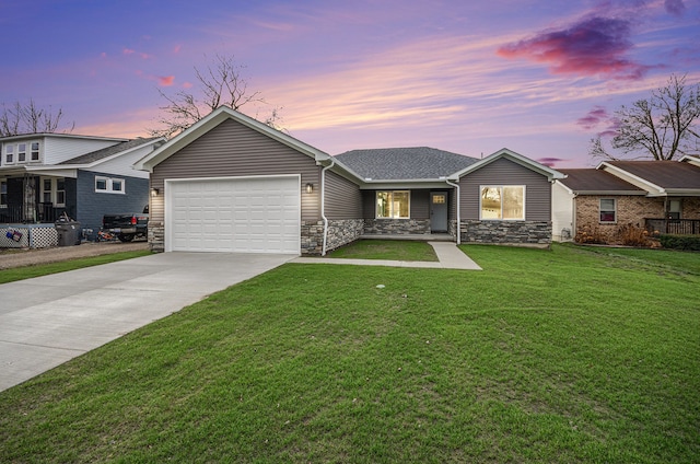 ranch-style home featuring a yard and a garage