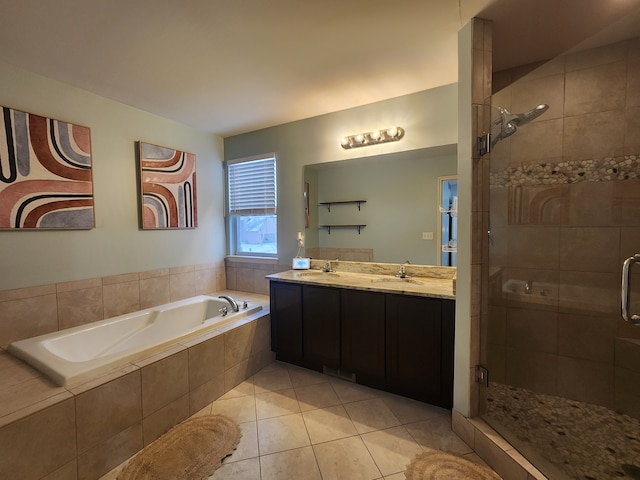 bathroom with tile patterned floors, vanity, and independent shower and bath