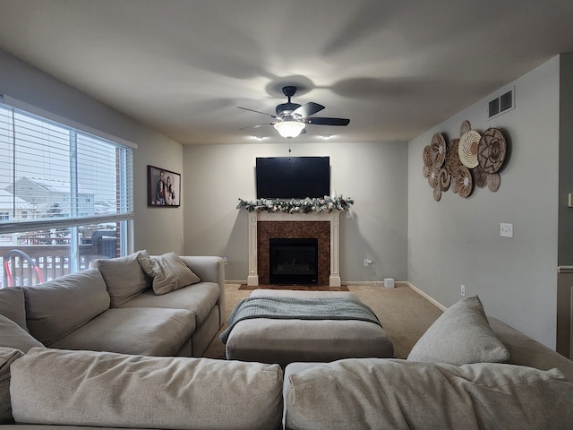 carpeted living room with ceiling fan