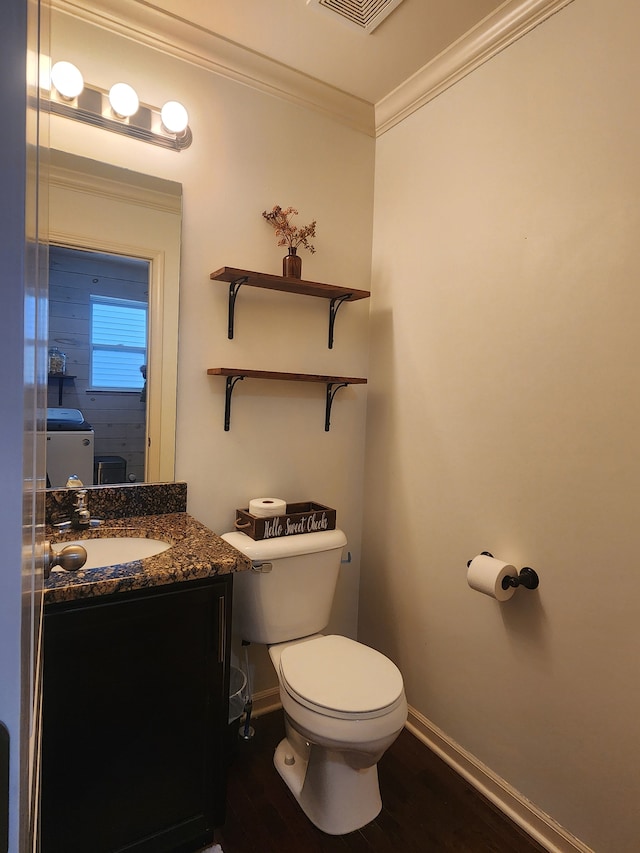 bathroom featuring ornamental molding, vanity, wood-type flooring, and toilet