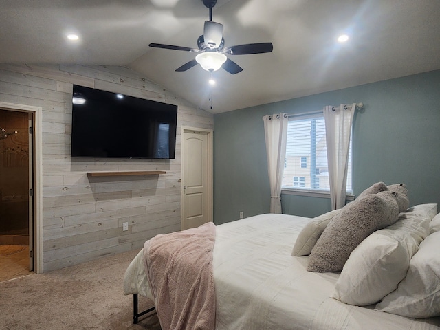 bedroom featuring carpet flooring, ceiling fan, a spacious closet, wood walls, and lofted ceiling