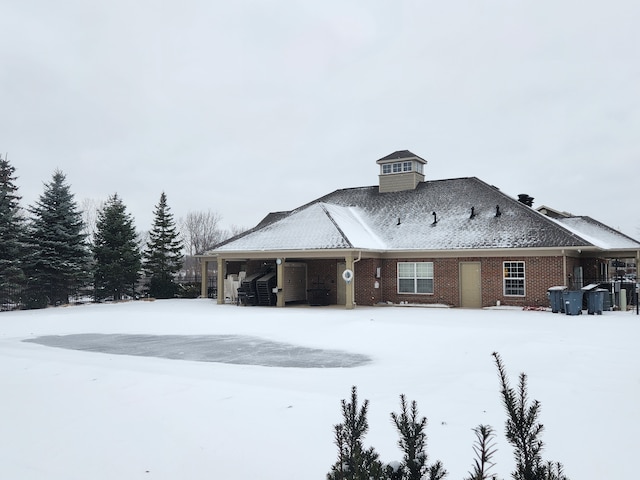 view of snow covered rear of property