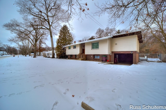 view of snow covered back of property