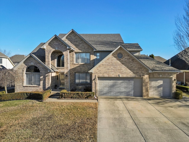 view of front of house featuring a front yard and a garage