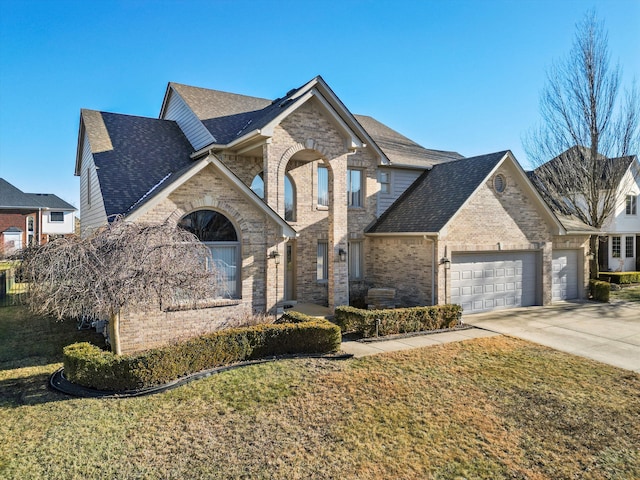 french provincial home with a garage and a front yard