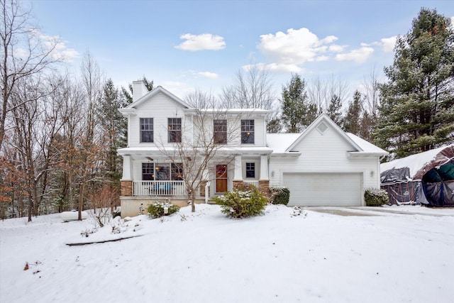 view of property with covered porch and a garage