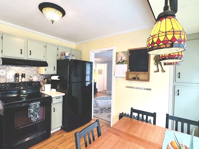 kitchen with black appliances, green cabinets, crown molding, light wood-type flooring, and tasteful backsplash