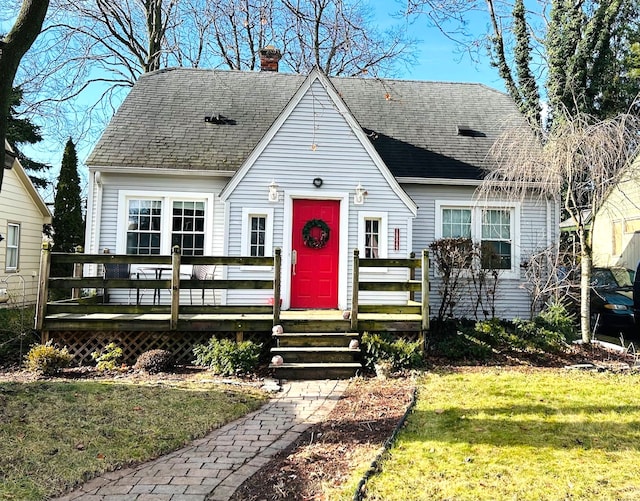 view of front of house with a front lawn and a deck