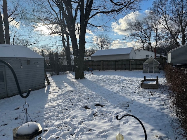 yard layered in snow featuring an outdoor structure