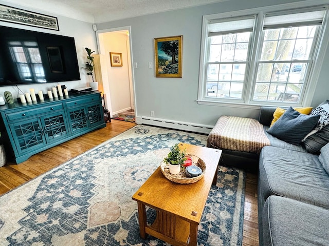 living room featuring hardwood / wood-style floors, a textured ceiling, and a baseboard radiator