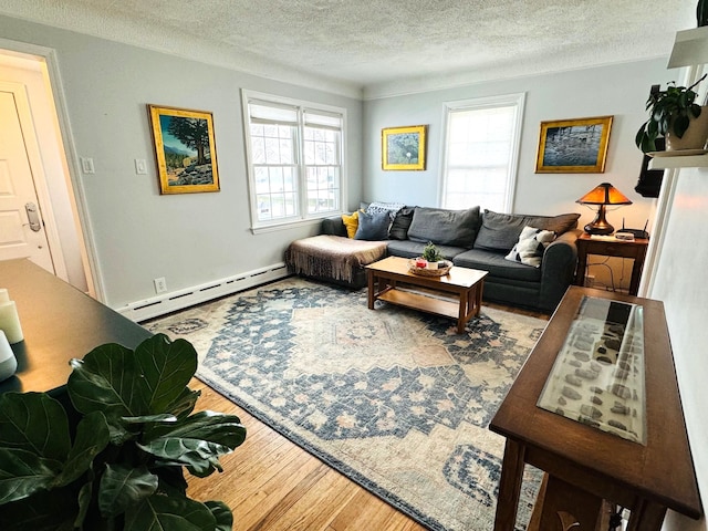 living room with a baseboard radiator, a textured ceiling, and hardwood / wood-style flooring