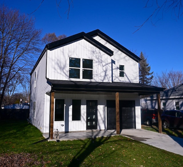 view of front of property featuring a garage and a front yard