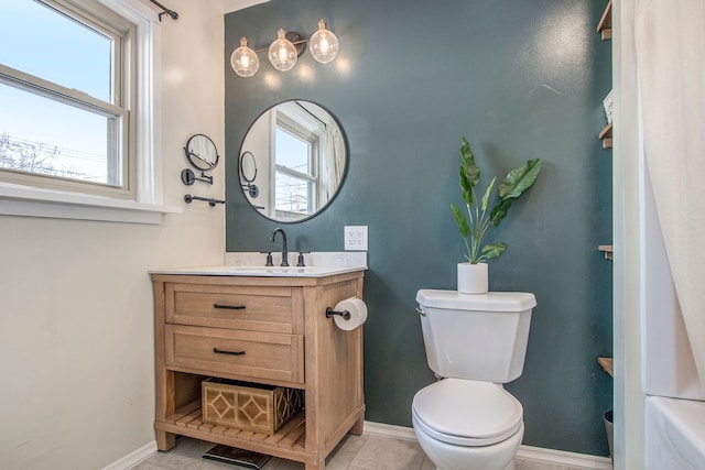 bathroom featuring tile patterned flooring, vanity, and toilet