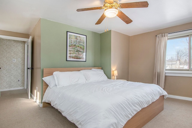 bedroom featuring ceiling fan and light carpet