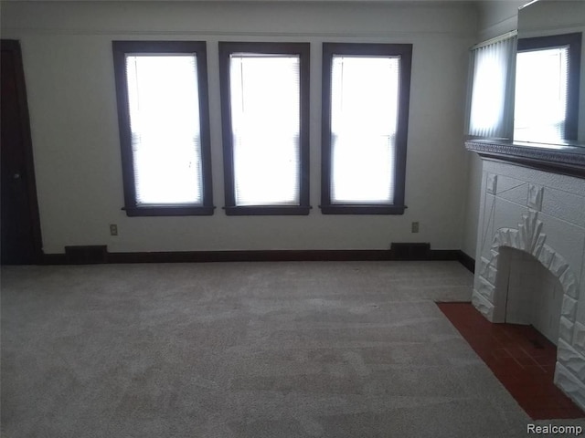 unfurnished living room featuring dark carpet