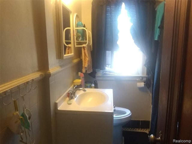 bathroom featuring vanity and toilet