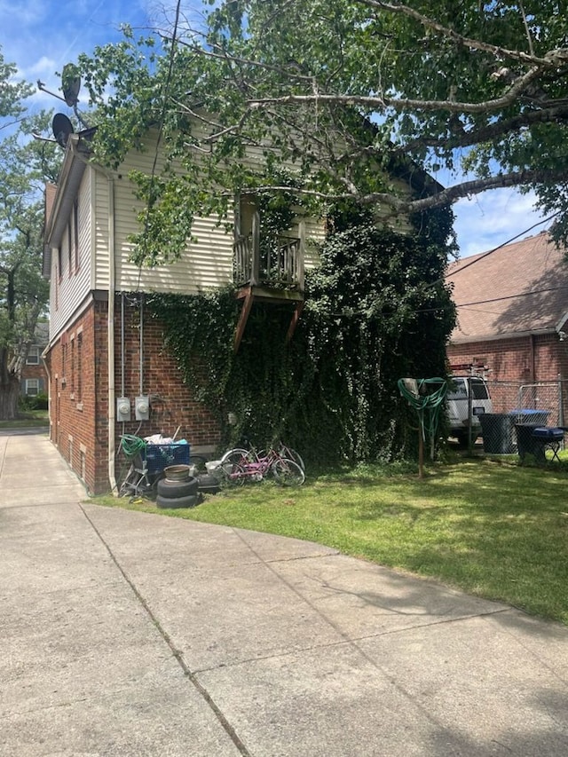 view of property exterior with a lawn