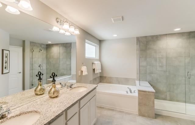 bathroom featuring tile patterned flooring, vanity, and shower with separate bathtub