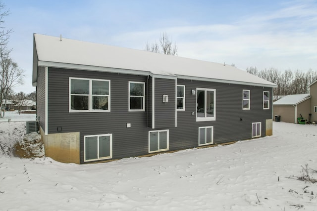 view of snow covered back of property