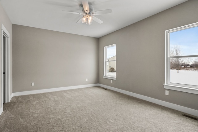 carpeted spare room with ceiling fan