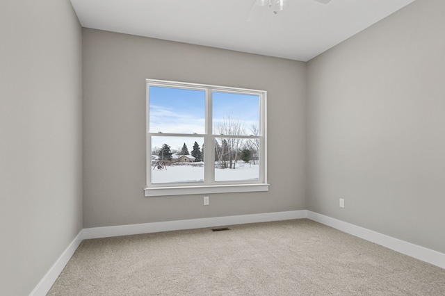 empty room featuring ceiling fan and carpet flooring