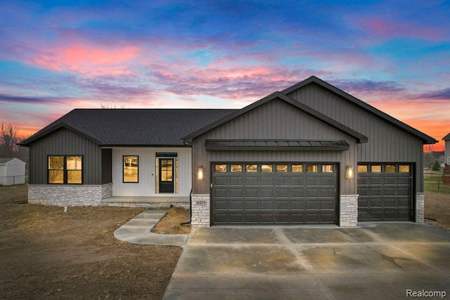 9033 Copper Ridge Dr, Davison, MI 48423 - modern farmhouse style home featuring an attached garage, driveway, stone siding, and covered porch