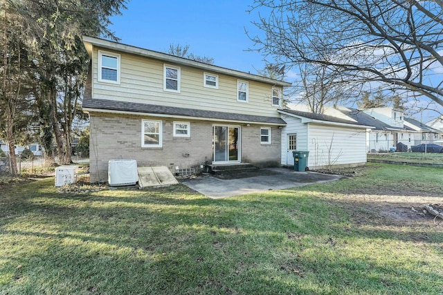 rear view of house featuring a lawn and a patio area