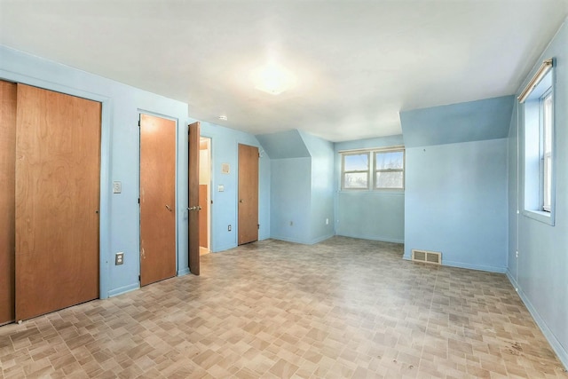 spare room with vaulted ceiling