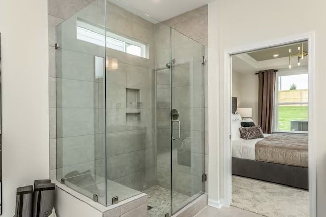 bathroom with a shower with door and a wealth of natural light