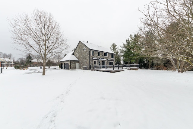 view of snow covered rear of property