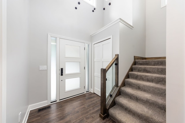 entryway featuring dark hardwood / wood-style flooring and a high ceiling