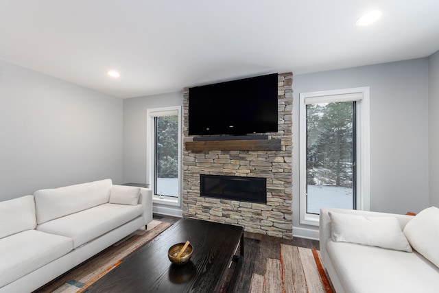 living room with dark wood-type flooring and a fireplace