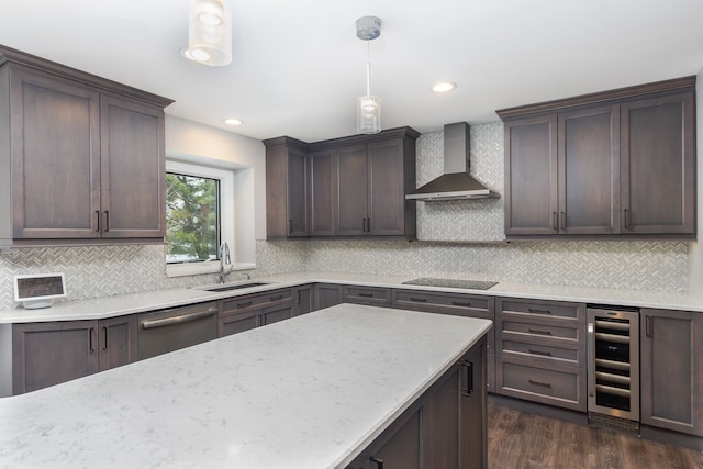 kitchen with sink, wall chimney range hood, decorative light fixtures, stainless steel dishwasher, and beverage cooler